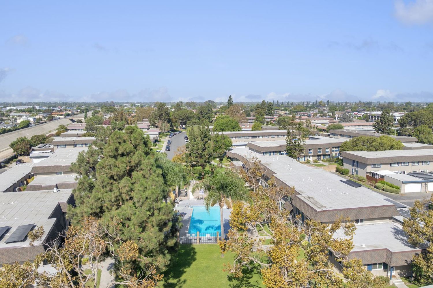 Rooftops and tree-lined streets across Cypress Tanglewood from above